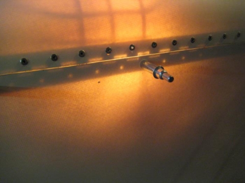 Backlight method to locate hinge holes in cowl