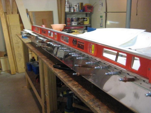 A level used as a straight edge on the hinge.