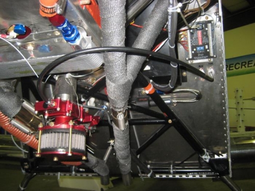 Black throttle cable out firewall and curving to carb.