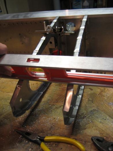 Aligning forward root rib with adjacent ribs, and clamping in place.