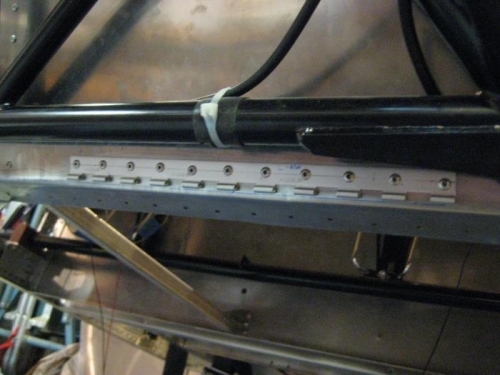 Hinge riveted in place.