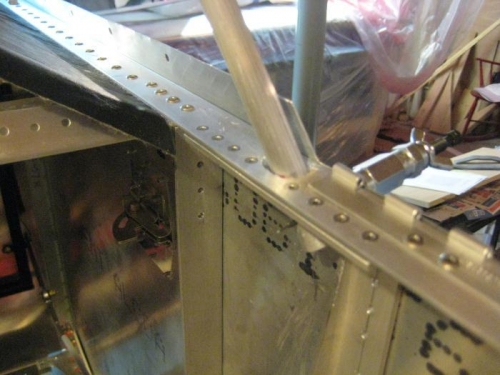 The bow protruding through the upper stringer, with a cleco to hold it in place.