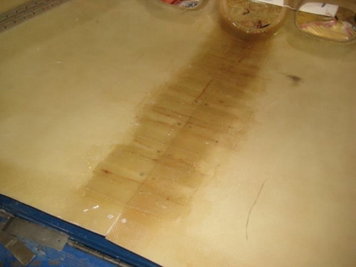 Final layers of glass along the top seam of the upper cowl.