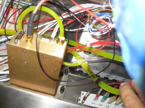 Tee fitting to the left of the word 