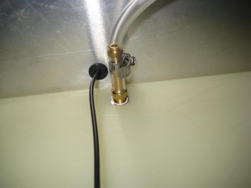 Top end of fuel sight tube attached to tank fitting.