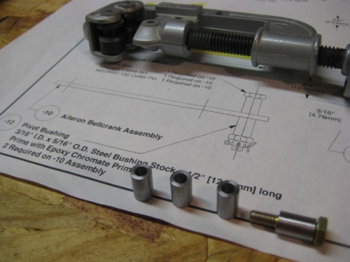Pipe cutter used to make 4 bushings in foreground.