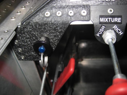 Black/blue knob is the locking pin for the canopy.