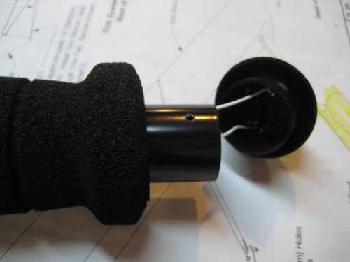 PTT switch in place in the grip cap, with wires through control stick. Set screw hole visible.