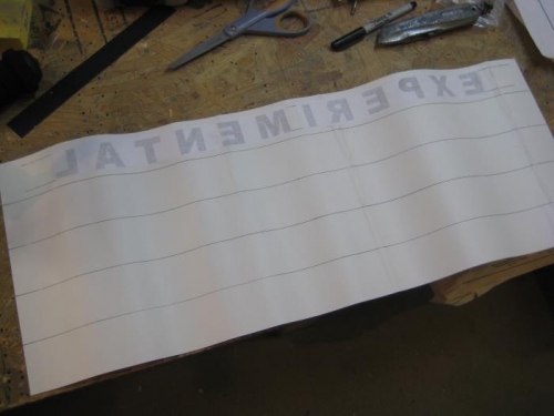 Back side of non-slip, with letters spray-cemented on.