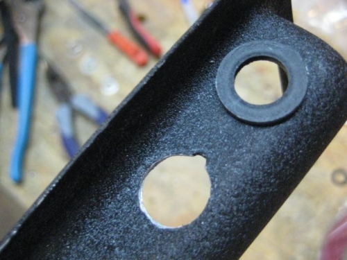 Enlarged hole at bottom. At top, shouldered gromet to isolate jacks.