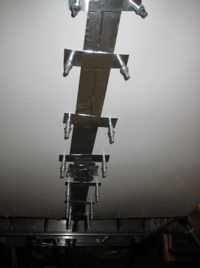 Aluminum tape along the seam at the bottom of the cowl.