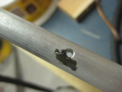 JB Weld in a slightly wallowed hole.