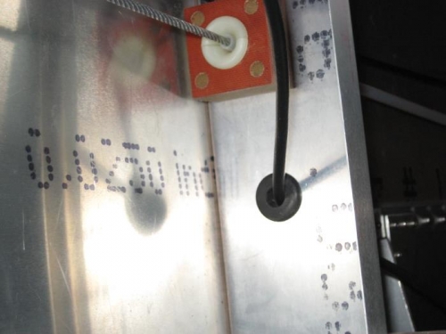 Antenna cable in rubber grommet through framing member