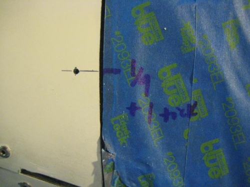 Cowl at left; tape on windscreen at right. Tape marks made with cowl off.