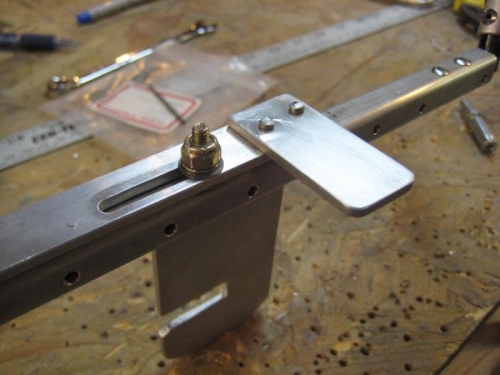 Slide handle riveted to the slide assembly.