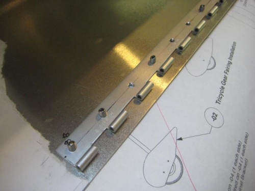 Starting to rivet the gear fairing hinge.