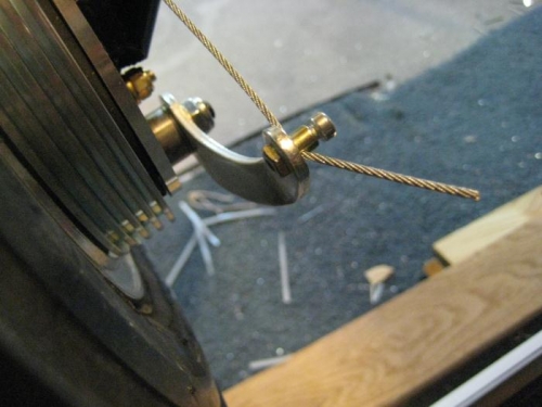 Cable secured at brake arm.