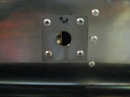 Stainless steel plate riveted to firewall, after drilliing hole for fuel fitting.