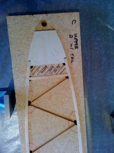 Nose rib layed in the jig.  Top and bottom cap strips, and one upright.