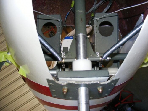 Closer view of nose gear assembly inside fuselage including steering connections and centering springs