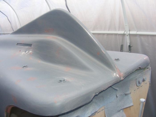 Top rear of Fuselage, Above Engine Mount.