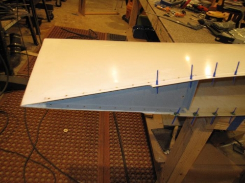 Wing tip rib riveted in place