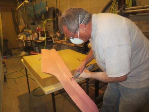 cutting the excess fiberglass away with the dremel tool