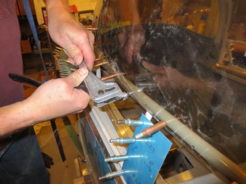 Riveting the canopy to the frame with temporary rivets