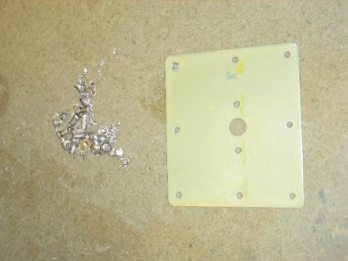 Freed up reinforcing plate, and remains of drilled-out rivets.