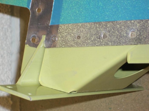 Pop rivet used in forward hole of lower rib.