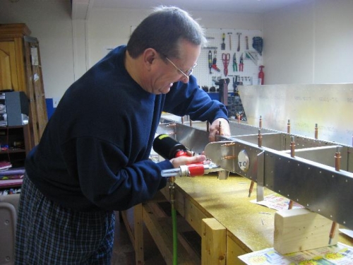 Riveting a bracket onto the front spar