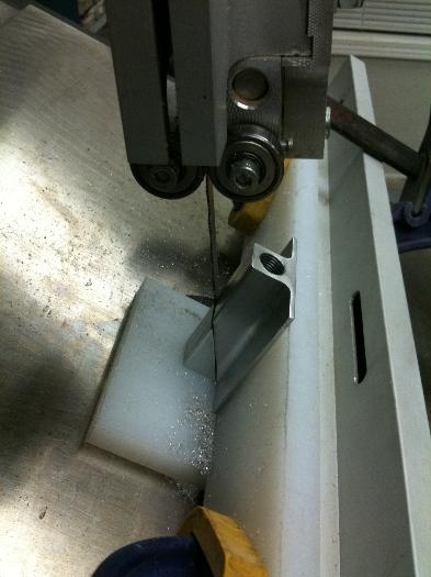 Bandsaw jigging to cut 30 degree slice off flaperon hinge bearing brackets