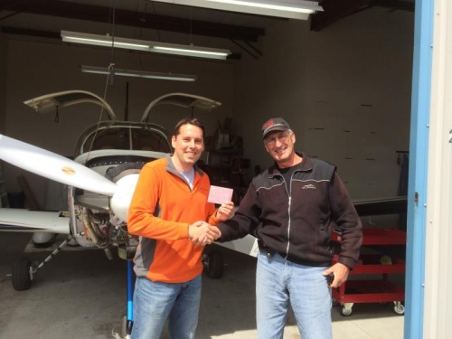 Gary Brown, acting on behalf of the FAA, signs off the airplane as Airworthy!