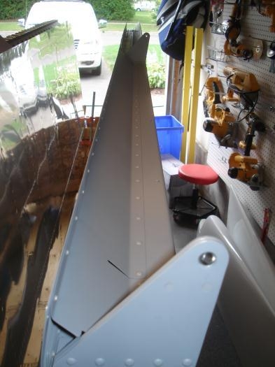 Right wing flap brace and aileron gap fairing riveted.