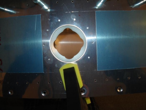 Fuel cap flange clamped in placed with the centre lines showing through the rivet holes