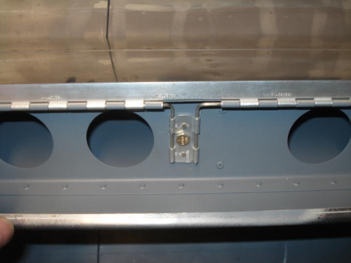 Hinge retaining pin bracket fabricated.