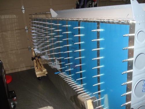 Right wing bottom skin rivet holes deburred.