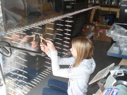 Lauren removing clecoes and inserting the rivets.