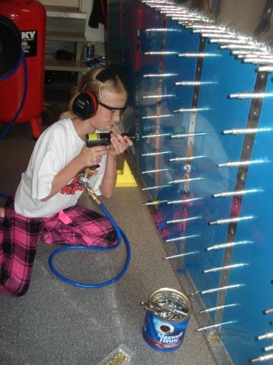 Lauren putting some umph into the rivet gun