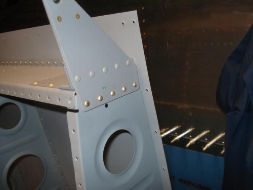 Outboard aileron bracket riveted in place