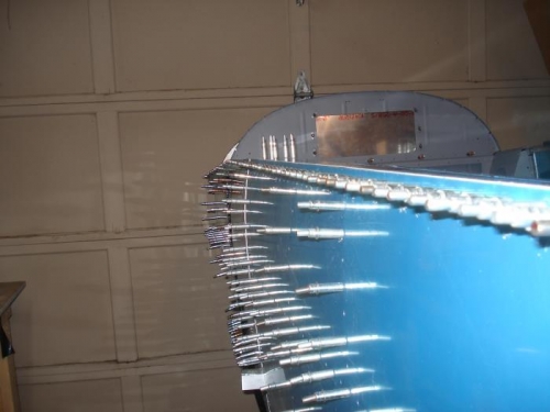 Front and mid skins and left longeron riveted in place