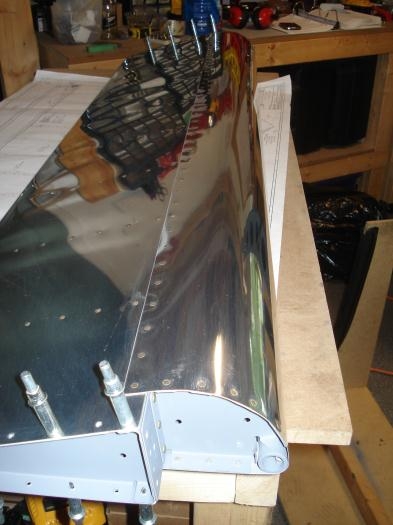 Left aileron top skin riveted.