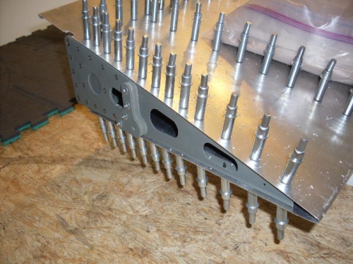 The shanks of the large rivets on the frame will be ground off