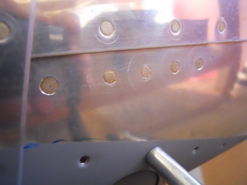 5 holes filled with NAS1097 rivets
