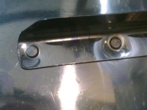 The stiffener is bending around the rivet