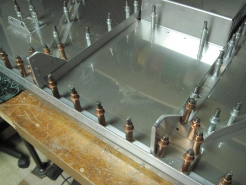 The lower center of the backside of the firewall, with the angle brackets at the bottom.