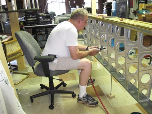 Dimpling the rib flanges with the pneumatic squeezer.