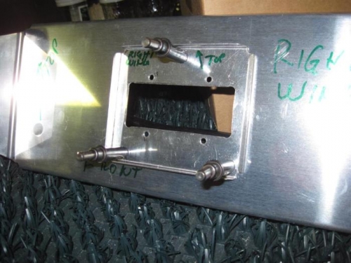 One of the light mounts fitted against the support bracket, with the edges turned up for stiffness.