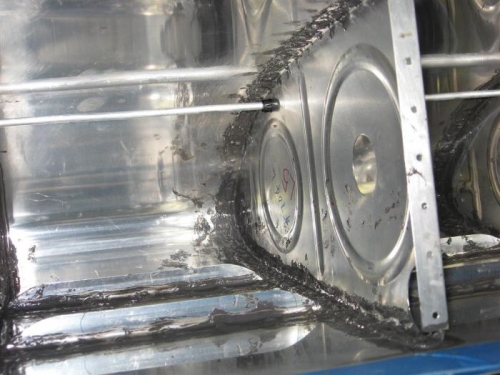 The additional sealer on the rib to skin joint, and the inside end of the rivets.
