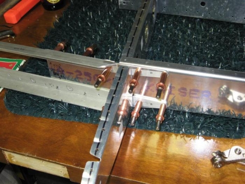 Center reinforcing/splice angles clecoed to the spar after drilling and removing the skin.